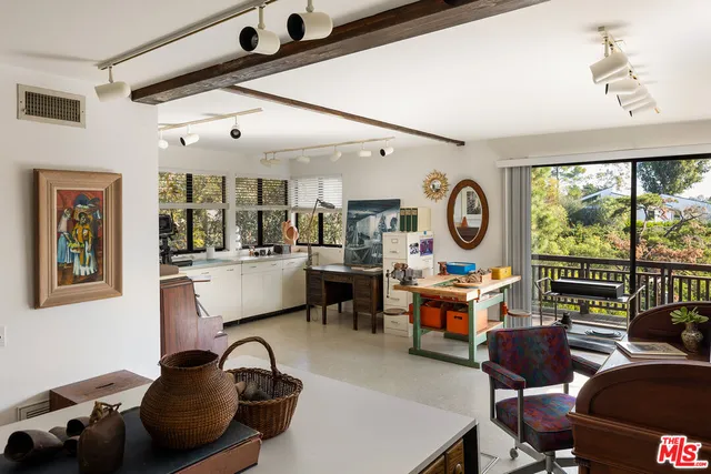 a living room with furniture a rug and a large window