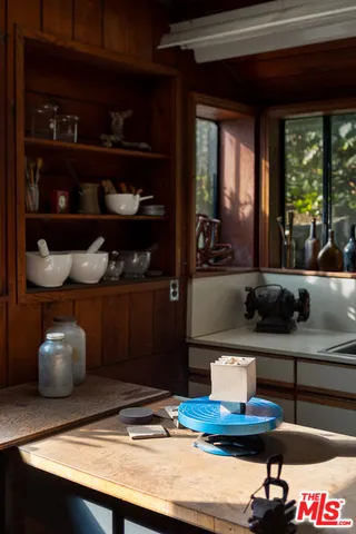 a kitchen with a stove and a wooden cabinets