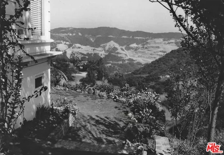 a view of a town with mountains in the background
