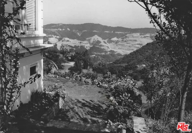 a view of a town with mountains in the background