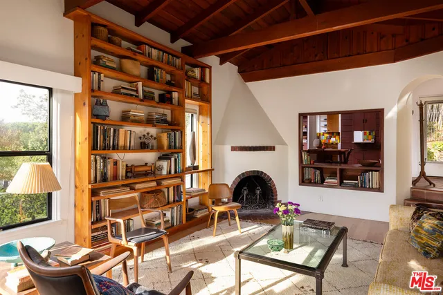 a living room with furniture a rug and a fireplace