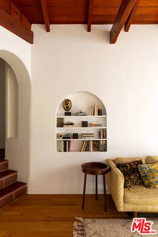 a living room with furniture and a floor to ceiling window