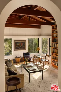 a living room with furniture and a floor to ceiling window