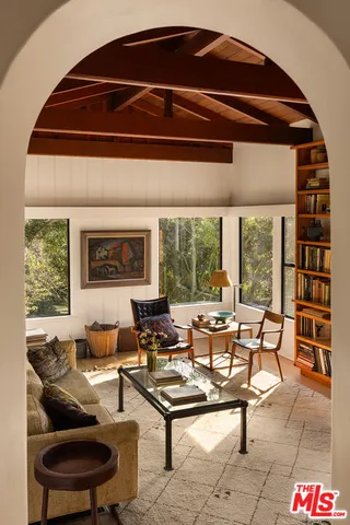 a living room with furniture and a floor to ceiling window
