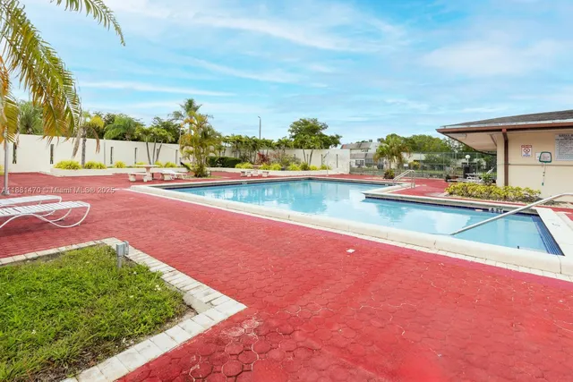 a view of a swimming pool with an outdoor space and seating area