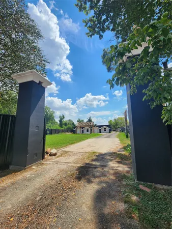 a view of a pathway with a yard