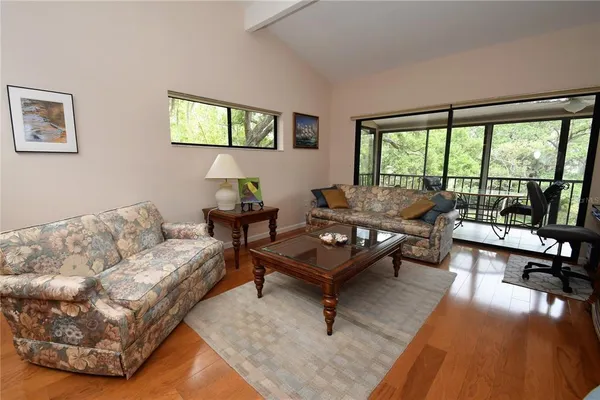 a living room with furniture and a floor to ceiling window