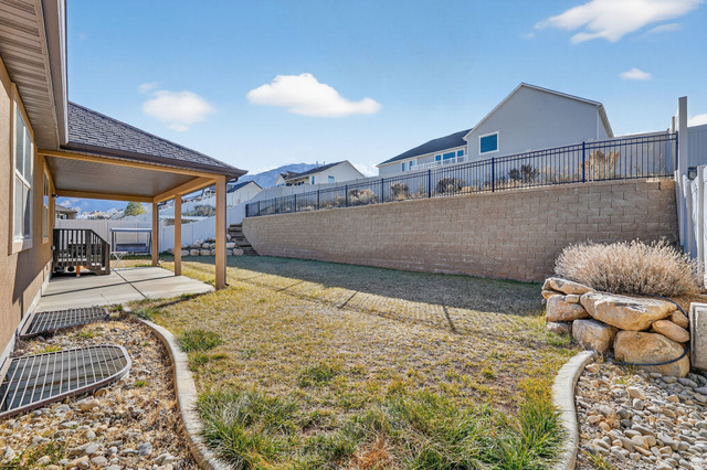 141 Wolverine Creek Elk Ridge, UT 84651 - Photo 35 of 47 Fenced backyard with a patio