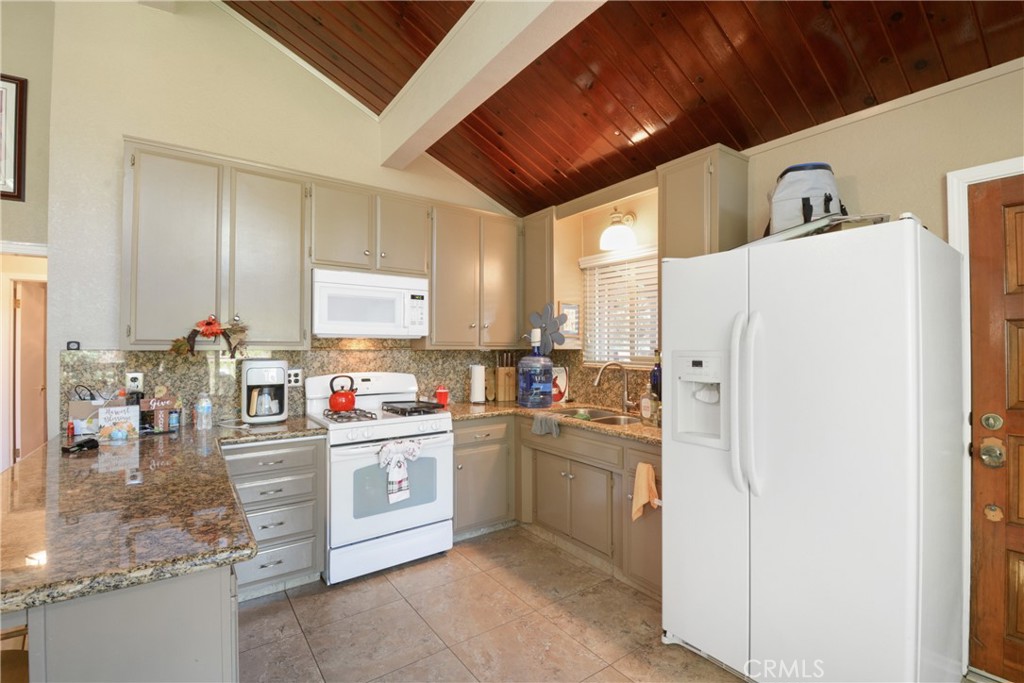 1942 Wilderness Road Running Springs, CA 92382 - Photo 12 of 20 a kitchen with stainless steel appliances granite countertop a refrigerator and a sink