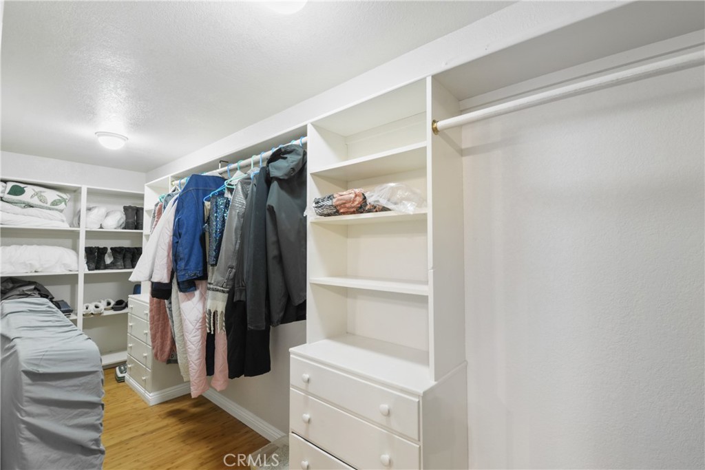 1942 Wilderness Road Running Springs, CA 92382 - Photo 16 of 20 a view of walk in closet with clothes and shoes