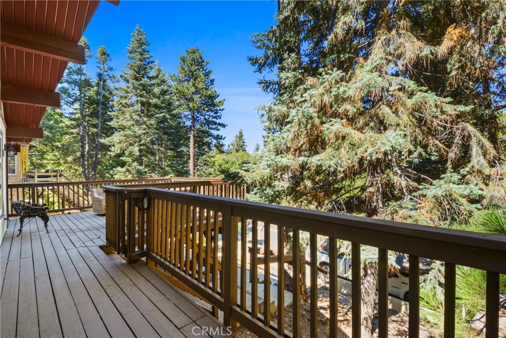 1942 Wilderness Road Running Springs, CA 92382 - Photo 9 of 20 a balcony with wooden floor and outdoor seating