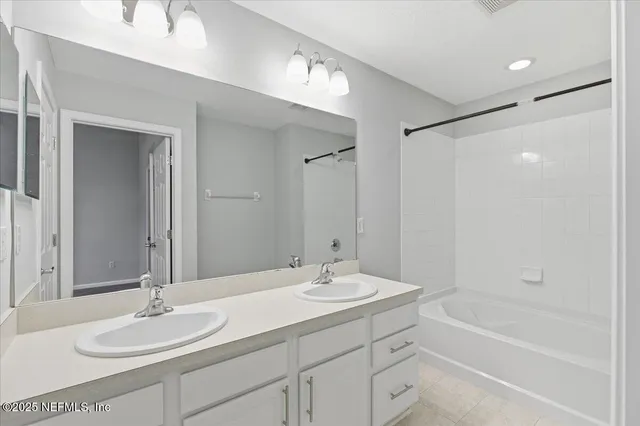 a bathroom with a granite countertop sink tub and a mirror
