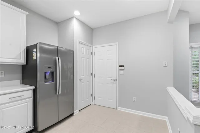 a kitchen with stainless steel appliances a refrigerator and cabinets