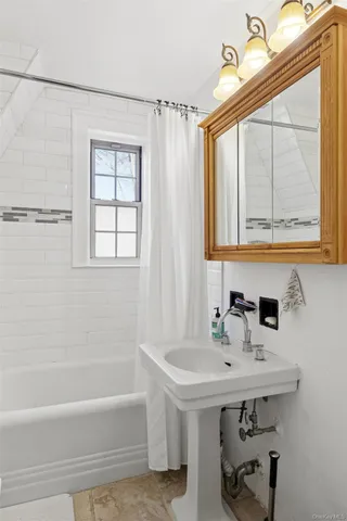 a living room with furniture a flat screen tv and a couch