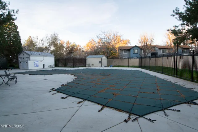 a backyard of a house with table and chairs