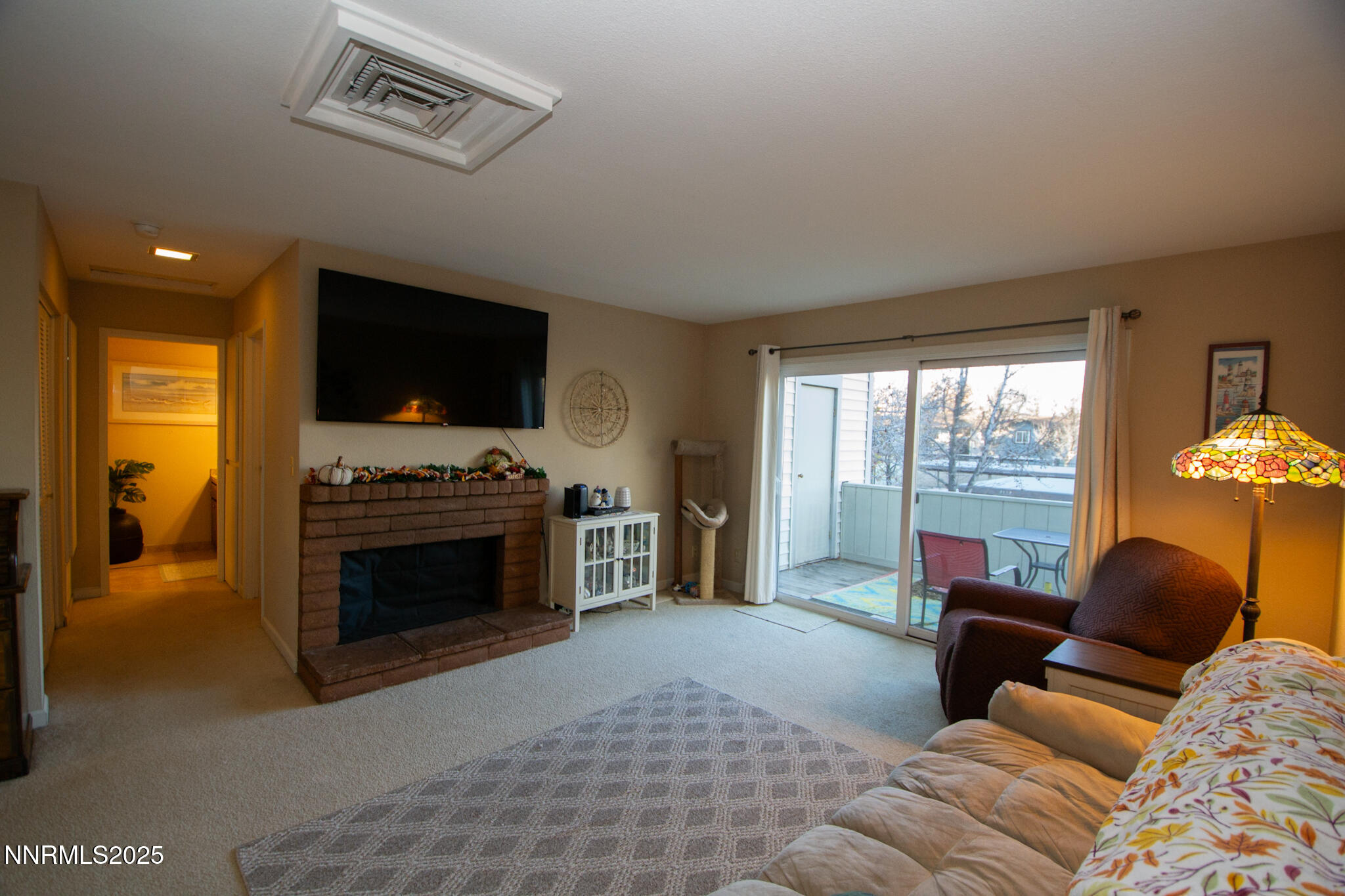 2127 Roundhouse Road Sparks, NV 89431 - Photo 4 of 20 a living room with furniture a fireplace and a flat screen tv