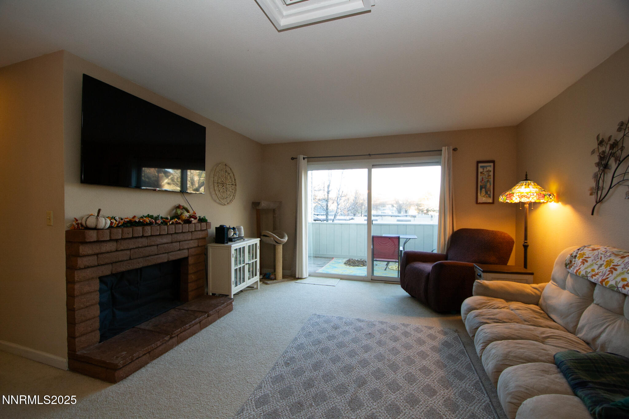 2127 Roundhouse Road Sparks, NV 89431 - Photo 5 of 20 a living room with furniture a flat screen tv and a fireplace