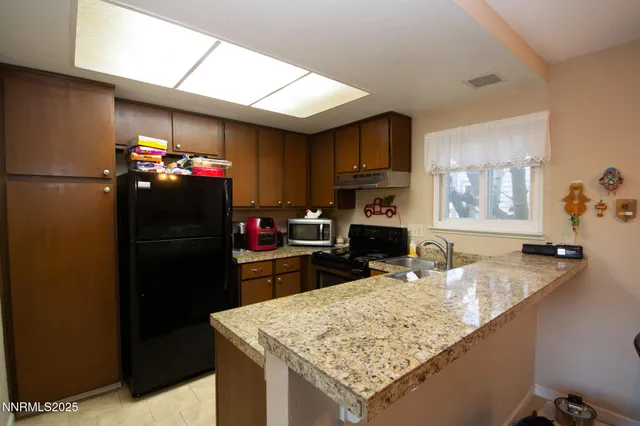a kitchen with a sink refrigerator and microwave