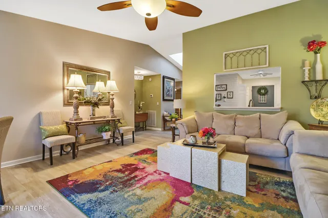 a kitchen with cabinets stainless steel appliances and wooden floor