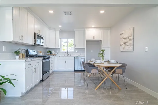 a kitchen that has a table and chairs in it