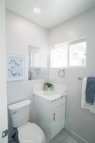 a bathroom with a sink mirror and toilet