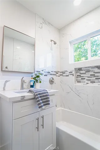 a bathroom with a bathtub and a sink