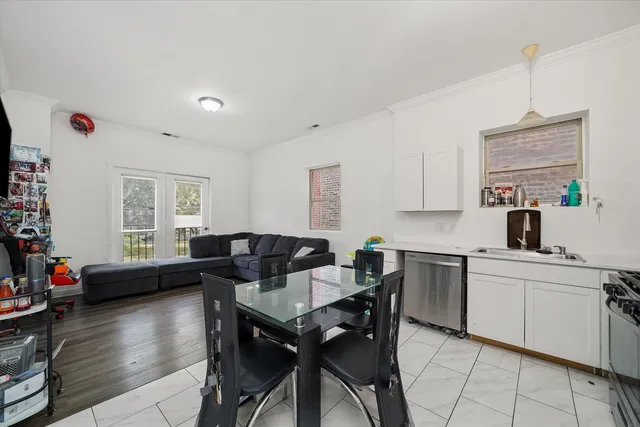 a kitchen with a table chairs stove and cabinets