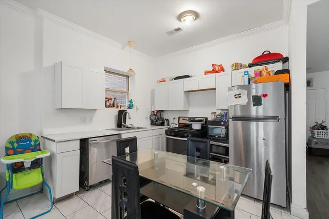 a kitchen with refrigerator and cabinets