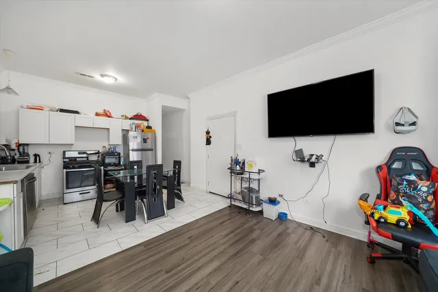 a view of a livingroom with furniture and a flat screen tv