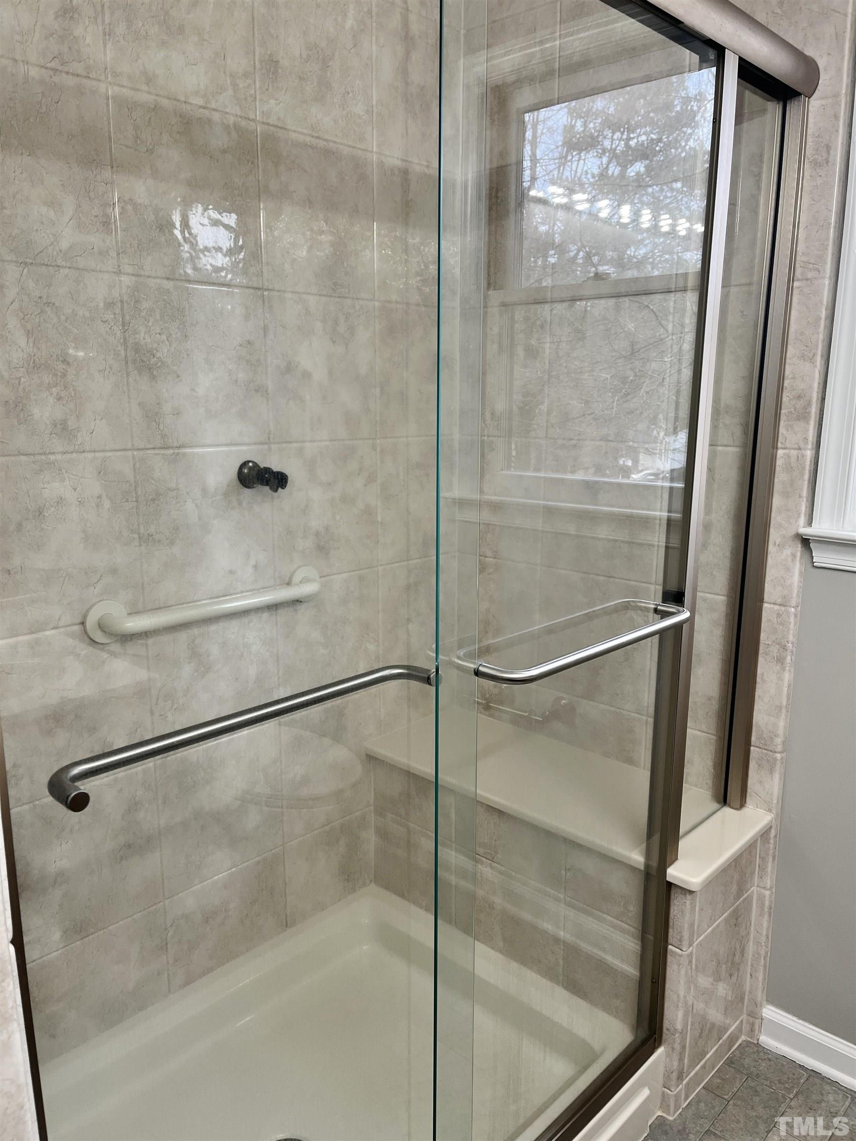 4509 Lafferty Court Raleigh, NC 27616 - Photo 11 of 17 a bathroom with a glass shower door