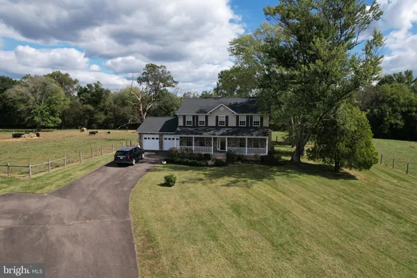 a view of a house with pool and a yard