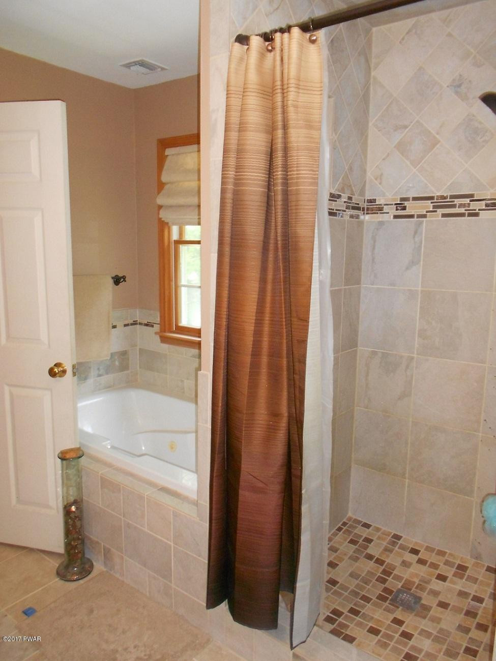 271 Sawmill Road Greentown, PA 18426 - Photo 16 of 36 a bathroom with a bathtub and shower