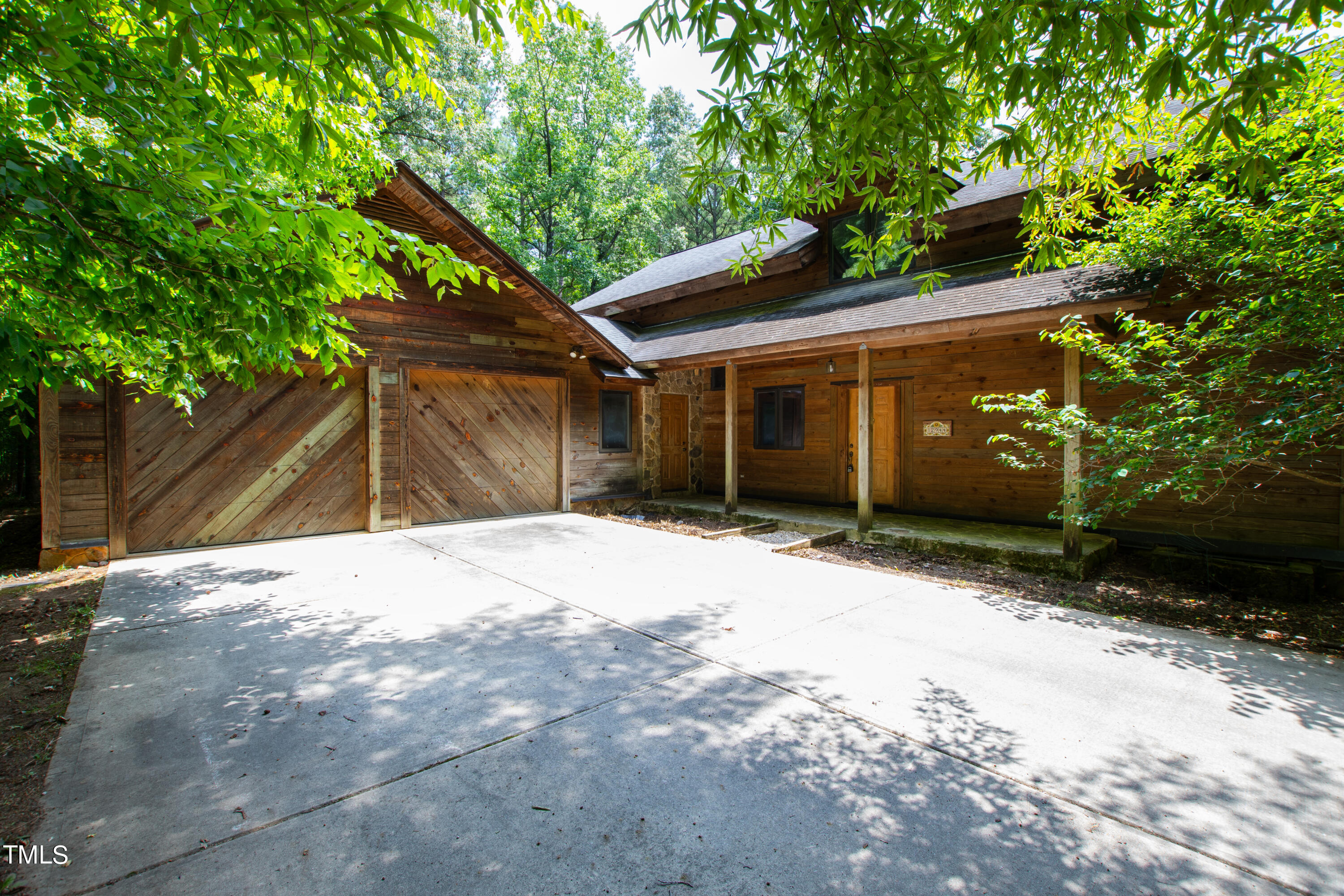 12944 Old Creedmoor Road Raleigh, NC 27613 - Photo 1 of 31 a front view of a house with a yard and garage