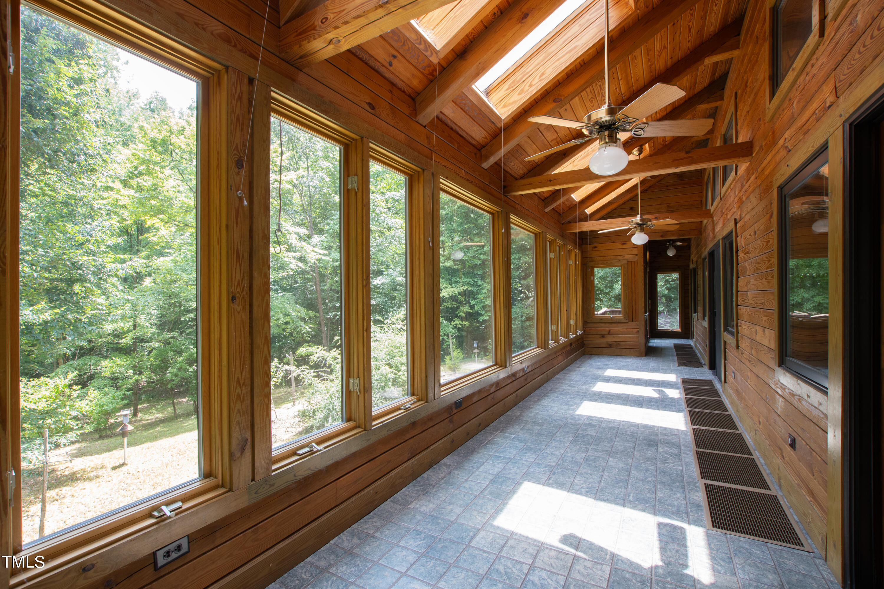 12944 Old Creedmoor Road Raleigh, NC 27613 - Photo 13 of 31 a view of a large room with wooden floor and windows