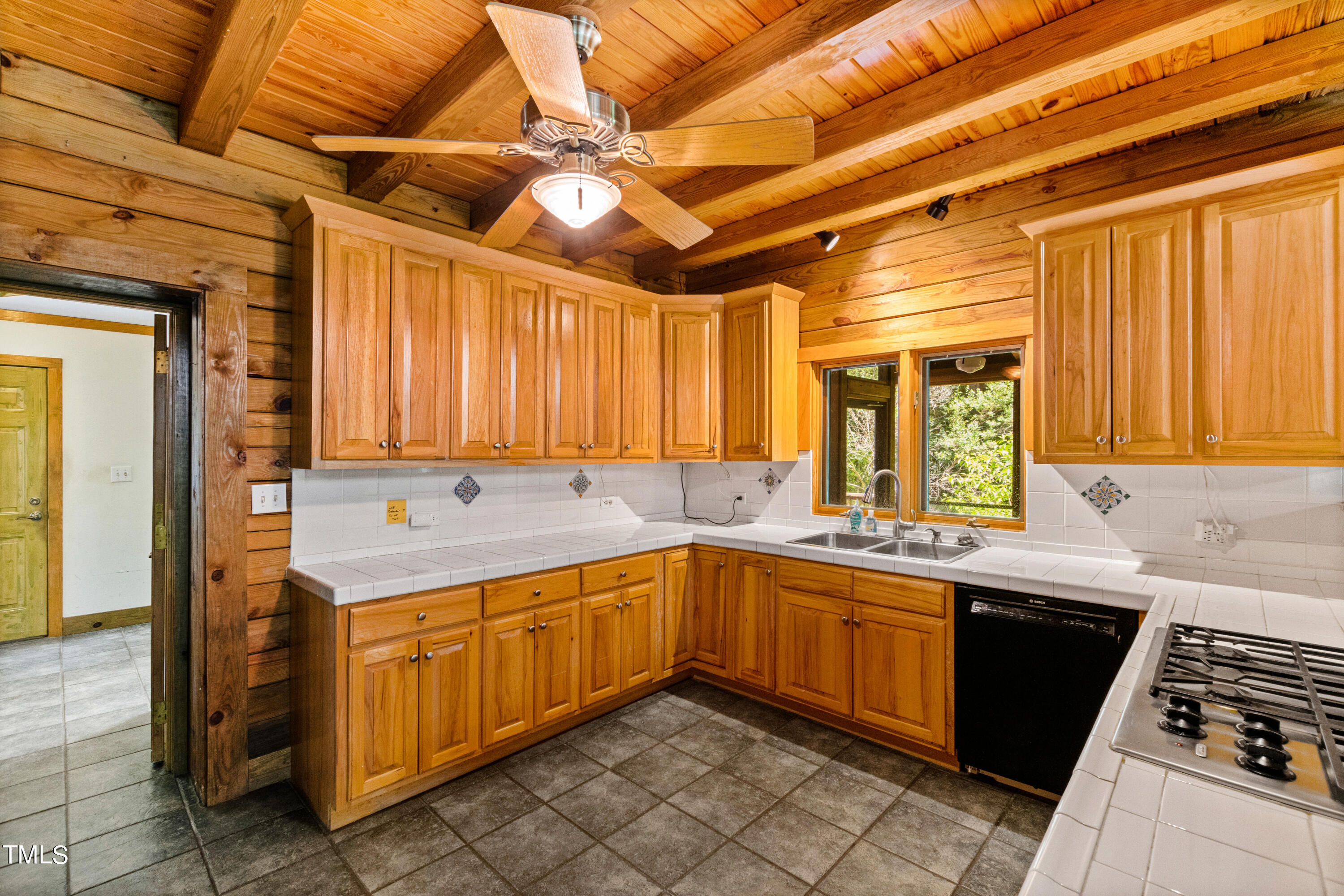 12944 Old Creedmoor Road Raleigh, NC 27613 - Photo 15 of 31 a kitchen with a sink and cabinets