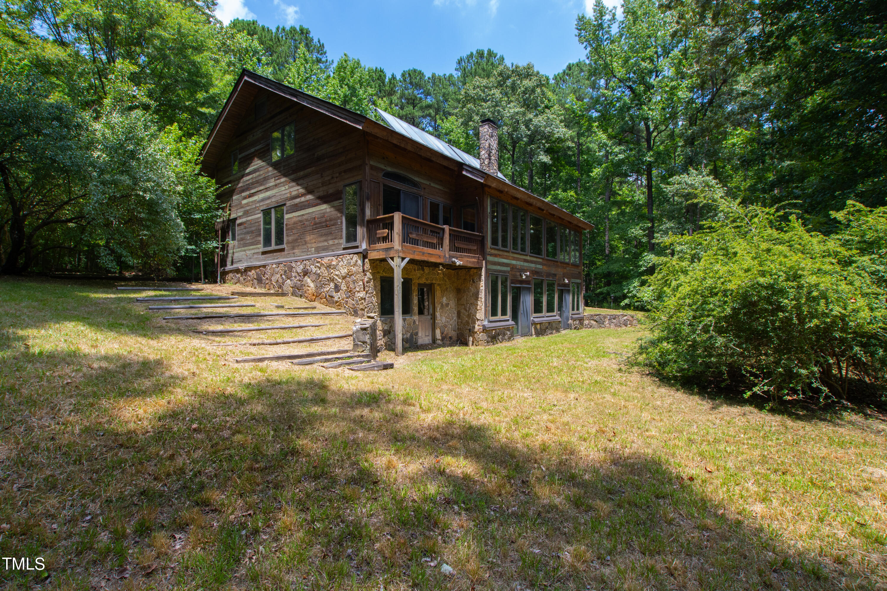 12944 Old Creedmoor Road Raleigh, NC 27613 - Photo 3 of 31 a view of a house with backyard and trees
