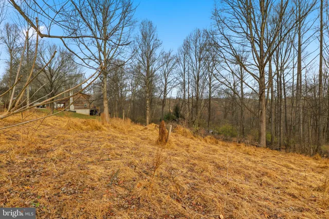 a view of yard covered with snow in front of house