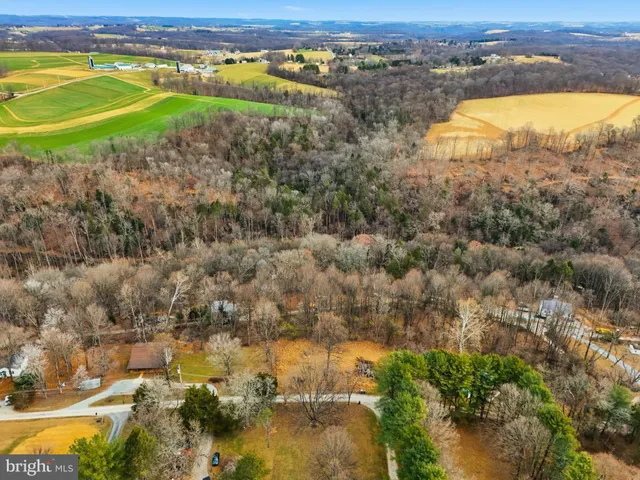 an aerial view of ocean beach and residential houses with outdoor space