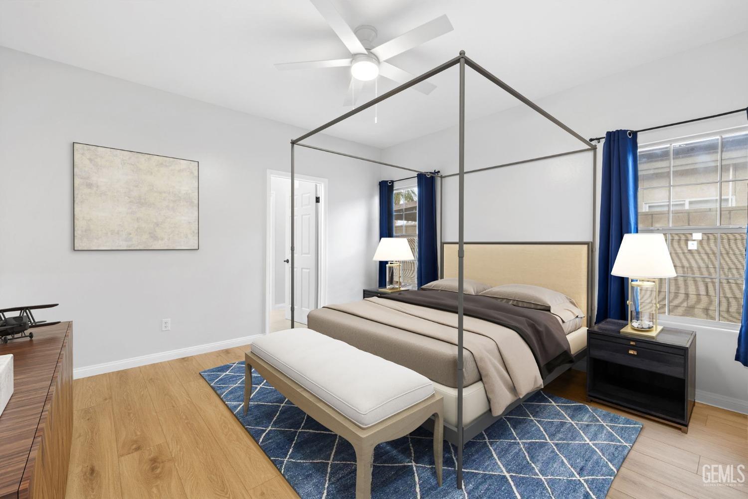 Undisclosed Address Bakersfield, CA 93312 - Photo 18 of 34 a bedroom with a bed and a lamp on table