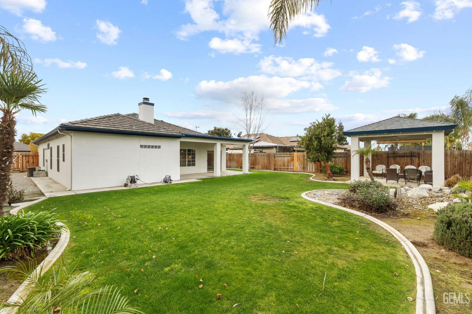 Undisclosed Address Bakersfield, CA 93312 - Photo 28 of 34 a view of a house with a backyard