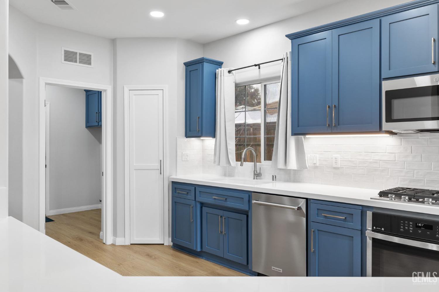 Undisclosed Address Bakersfield, CA 93312 - Photo 10 of 34 a kitchen with stainless steel appliances granite countertop a stove a sink and a refrigerator with wooden cabinets