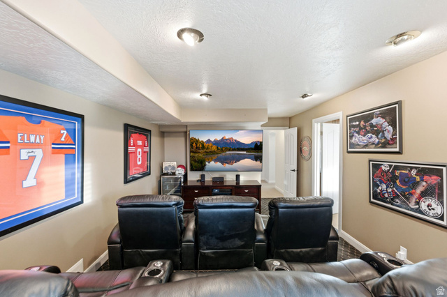 1878 East Ridge Point Drive Bountiful, UT 84010 - Photo 58 of 92 Home theater room featuring a textured ceiling and baseboards