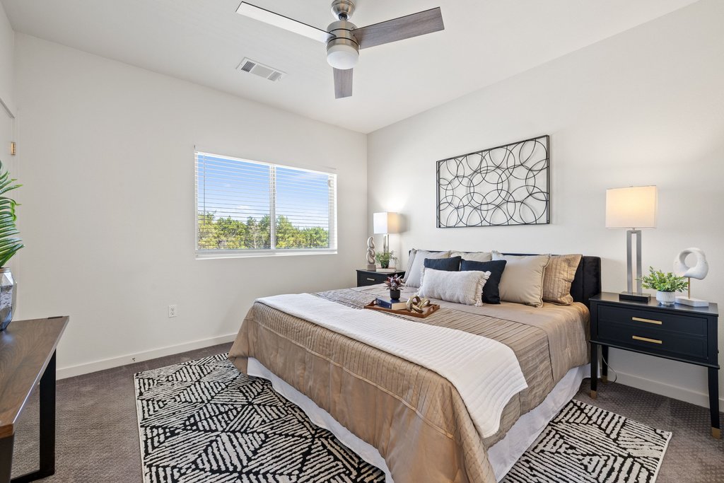 7805 Cooper Lane, Unit 401 Austin, TX 78745 - Photo 12 of 33 One of two light-filled primary bedrooms upstairs, large enough for king sized beds.