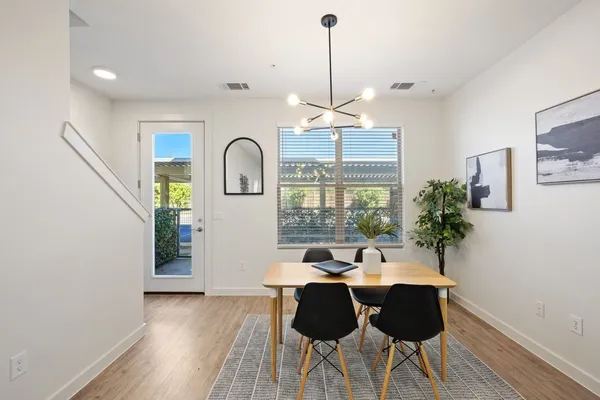 a view of a dining room with furniture window and wooden floor