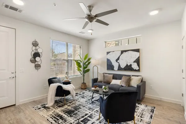 a living room with furniture and wooden floor