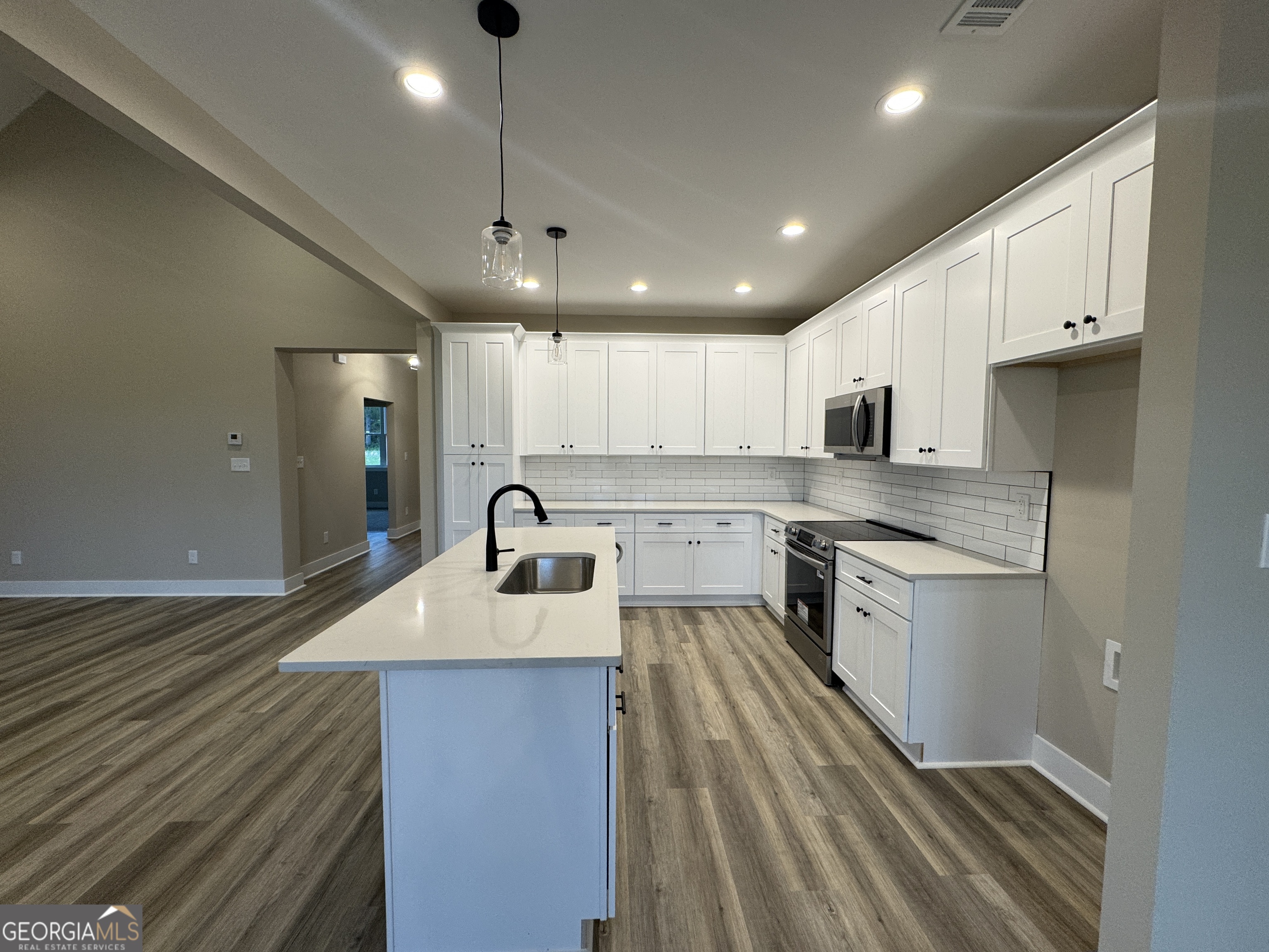 100 Melville Brown Road Williamson, GA 30292 - Photo 11 of 21 a large kitchen with kitchen island a sink stainless steel appliances and cabinets