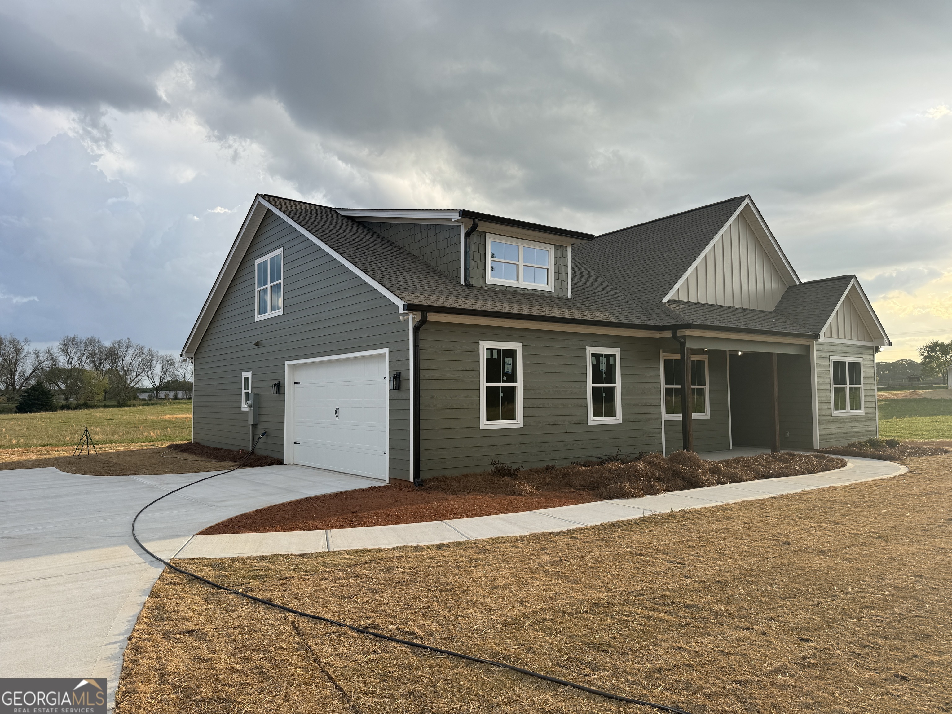 100 Melville Brown Road Williamson, GA 30292 - Photo 2 of 21 a front view of house with yard and lake view in back