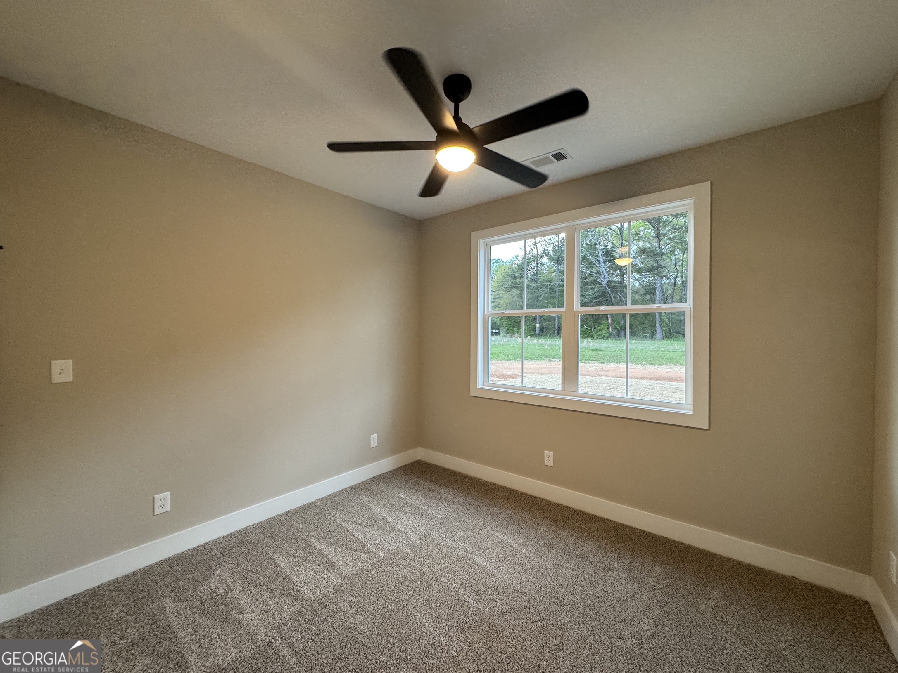 100 Melville Brown Road Williamson, GA 30292 - Photo 6 of 21 an empty room with ceiling fan and window