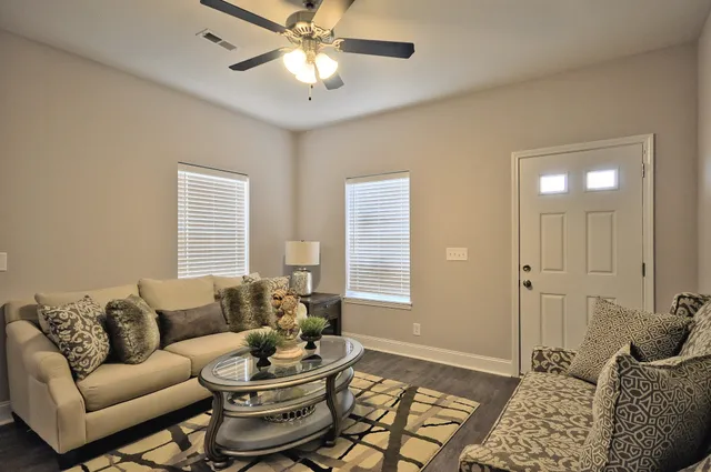 a living room with furniture and kitchen view