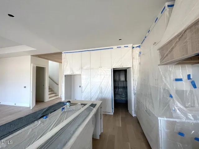 a kitchen with stainless steel appliances granite countertop a stove and a wooden floors